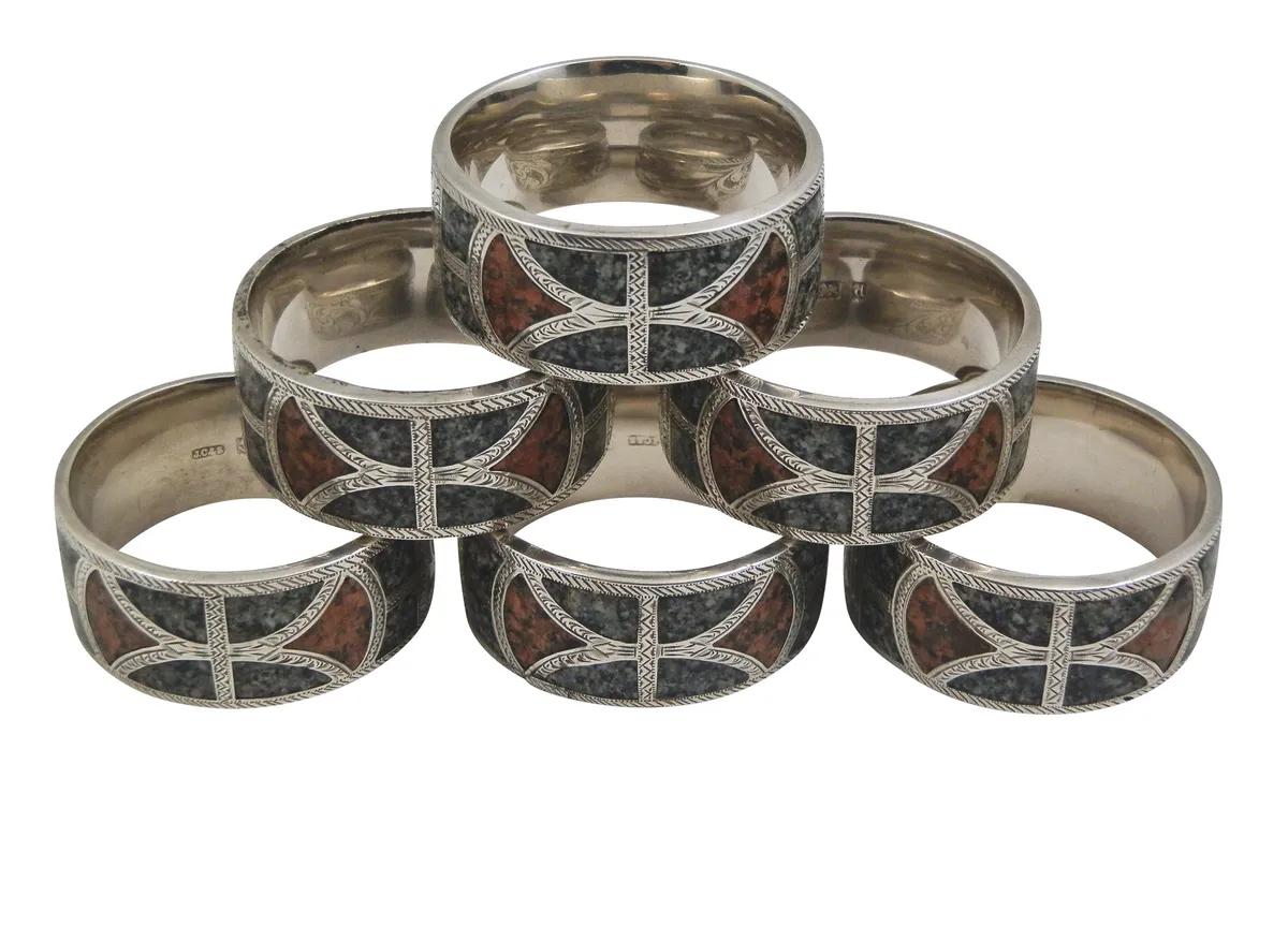 A set of six Edwardian silver rings inlaid with Aberdeen Rubislaw quarry granite (dark grey) and Aberdeenshire Corrennie granite (red). Made by Joseph Cook in 1904, £1,200, Highland Antiques