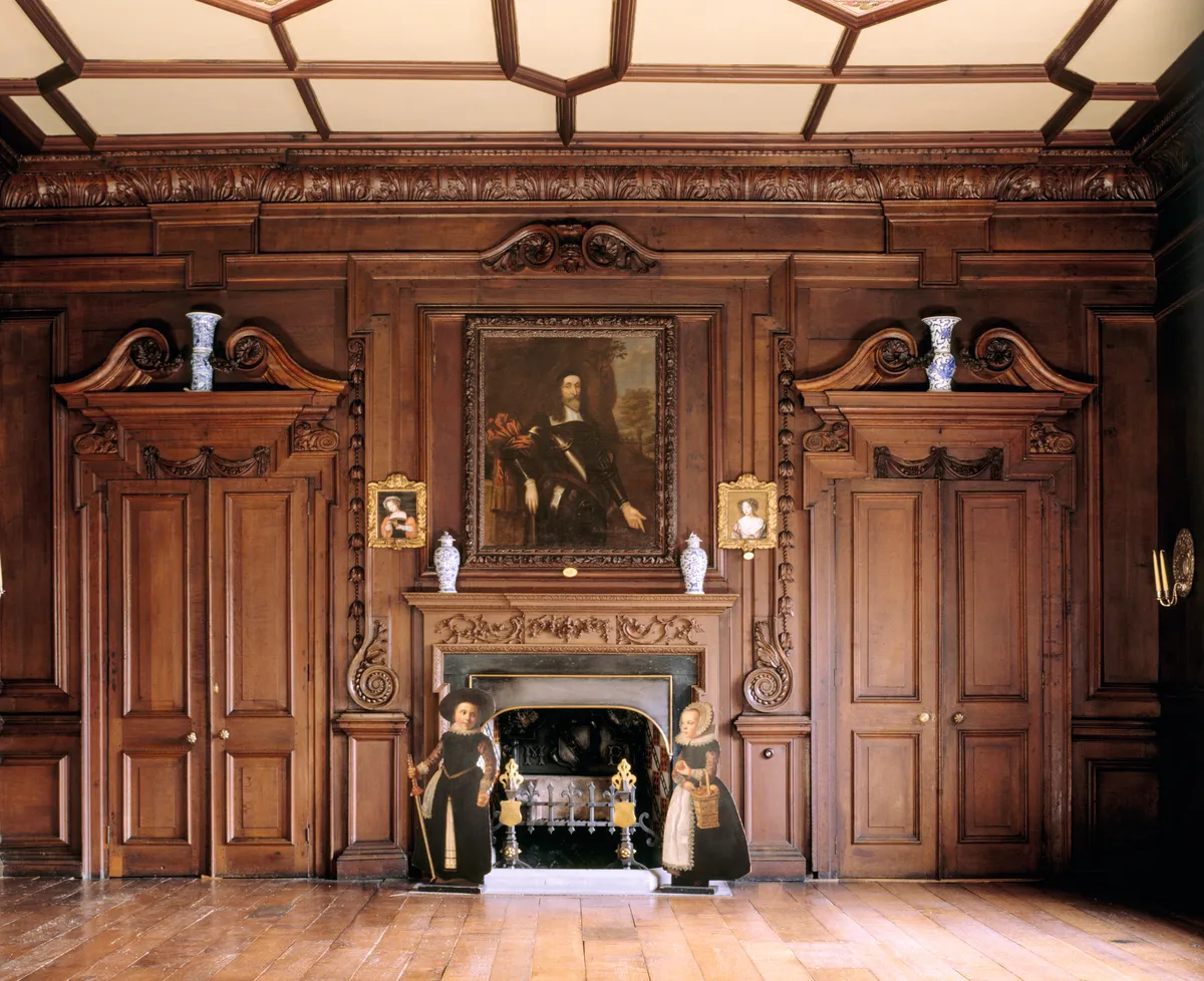 Partial view of the Rococo carved chimneypiece and dummy boards of children at the chapel end of the Long Gallery at Chirk Castle. ©National Trust Images/Andreas von Einsiedel