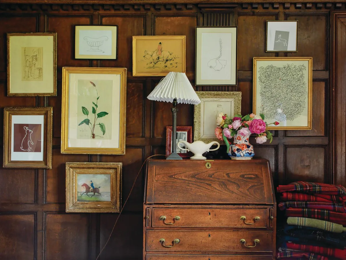 Wardington Manor: pictures and prints surround the antique desk.
