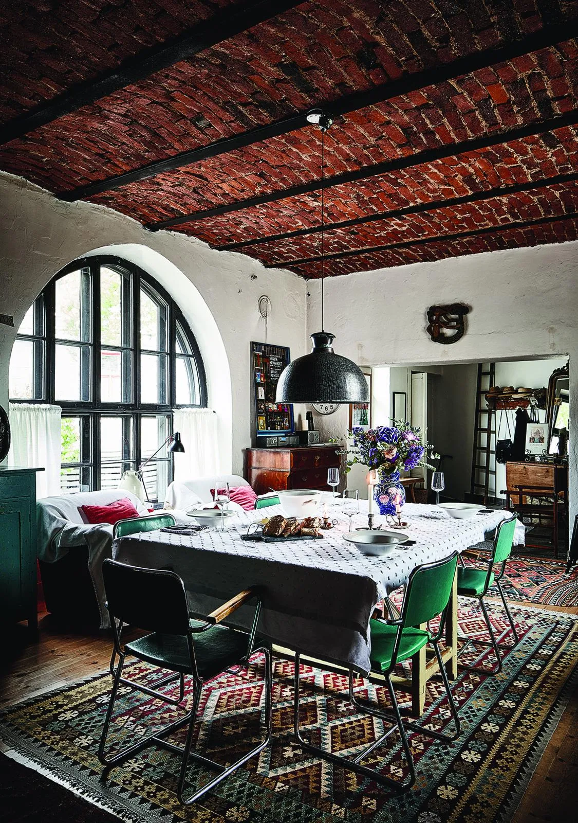Finnish former factory home: enormous arched window in the kitchen-dining room.