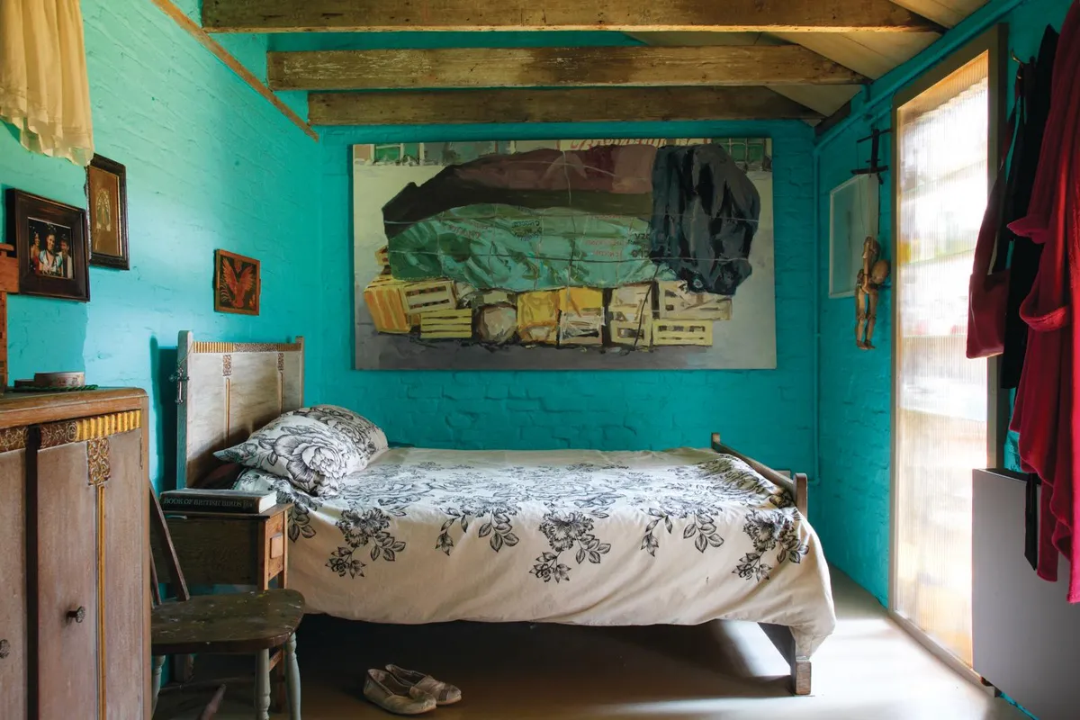 Converted builder's yard in South London, turquoise bedroom.
