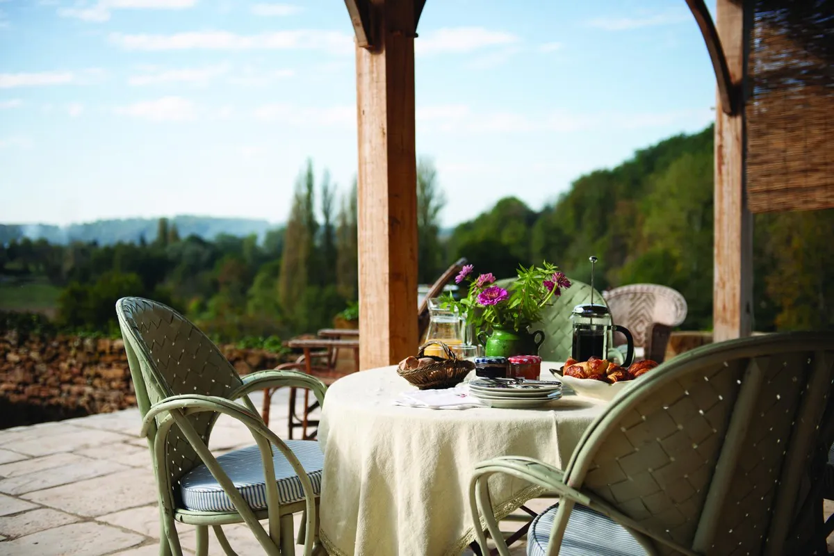 18th-century French farmhouse, dining on the terrace.