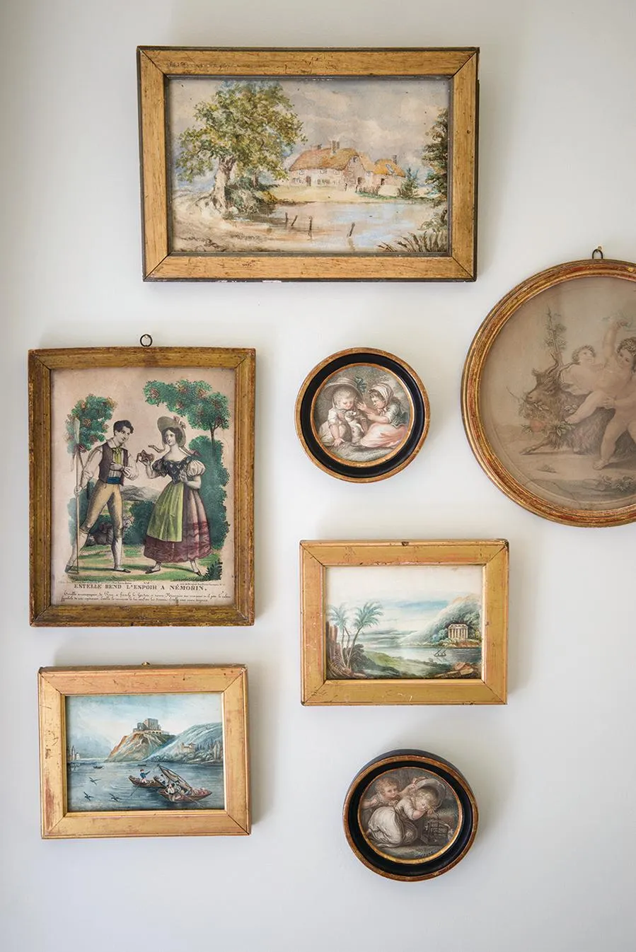 18th-century gamekeeper’s cottage, artworks hang in the bedroom.