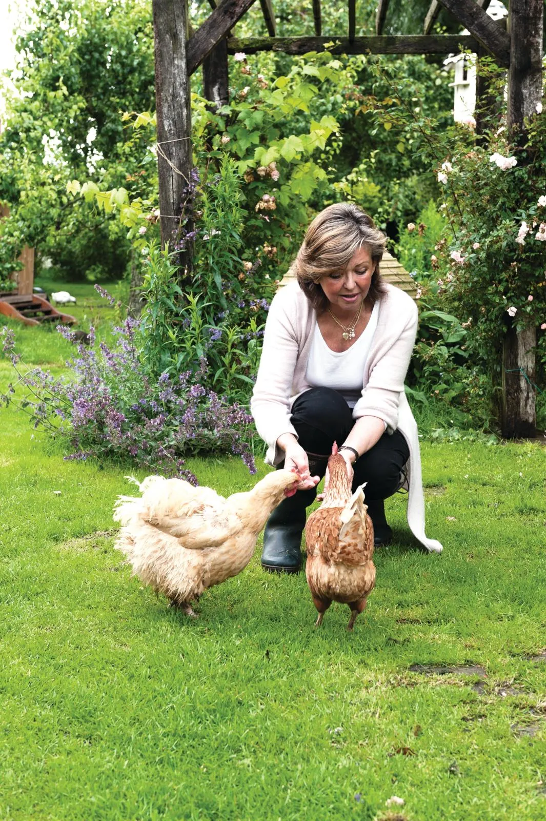 English country home owner Kate with her chickens