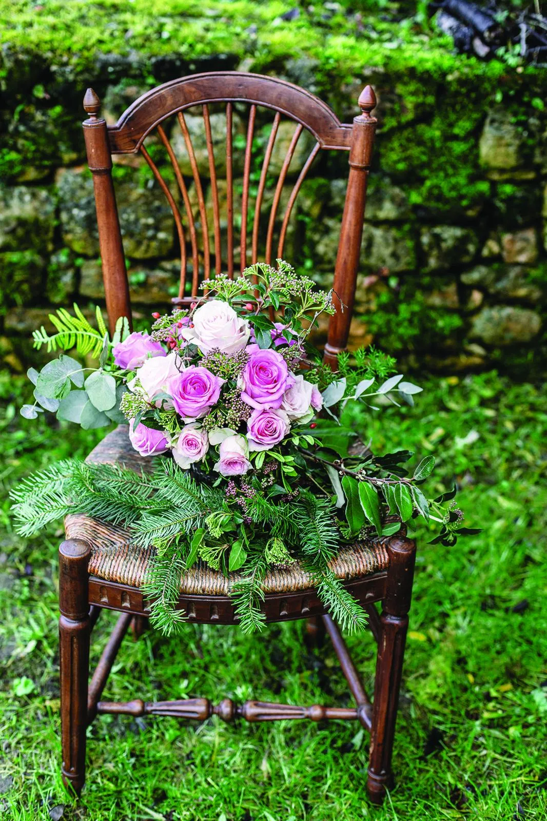 Renovated stone house, garden chair with blooms