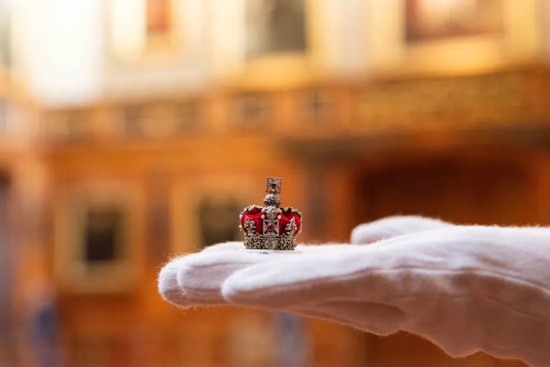 Curator Kathryn Jones prepares miniature items from Queen Mary’s dolls’ house for a special display in Windsor Castle’s Waterloo Chamber. These include a crown.