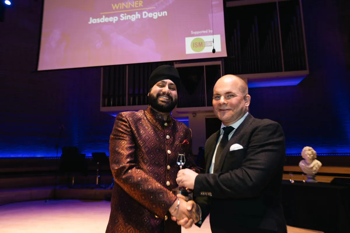A photo of Jasdeep Singh Degun and Wigmore Hall's John Gilhooly at the 2024 RPS Awards
