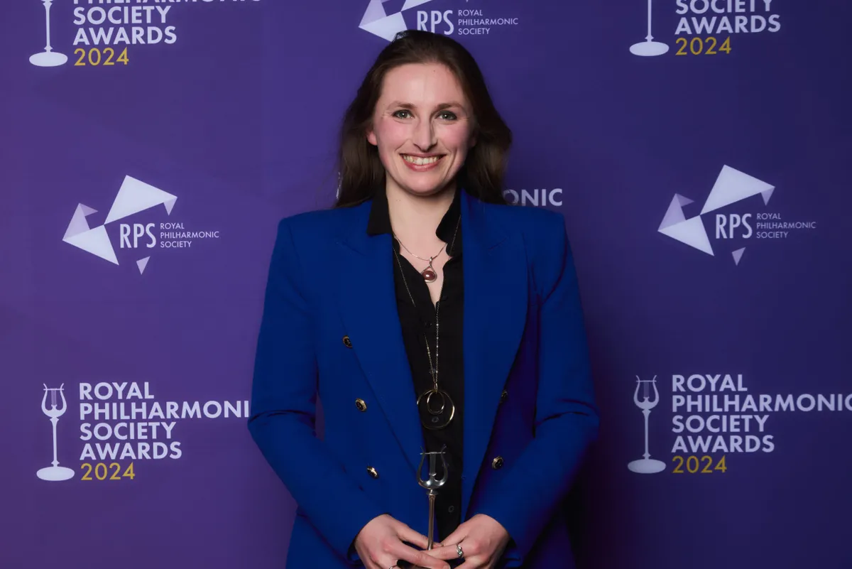 A photo of Leah Broad at the 2024 RPS Awards against a purple background