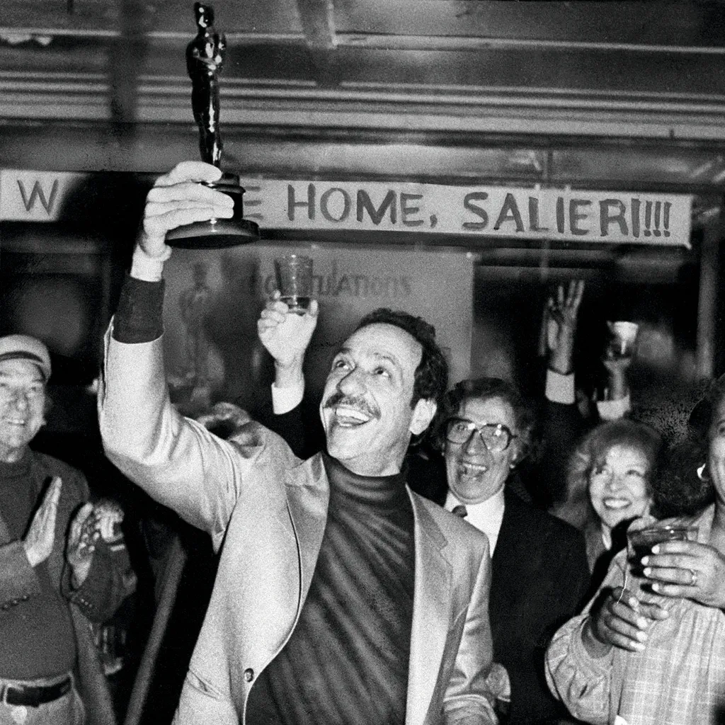 Actor F. Murray Abraham shows his new Oscar award to his neighbours in the lobby of his Eastern Parkway, New York apartment building 