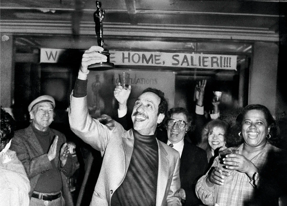 Actor F. Murray Abraham shows his new Oscar award to his neighbours in the lobby of his Eastern Parkway, New York apartment building 