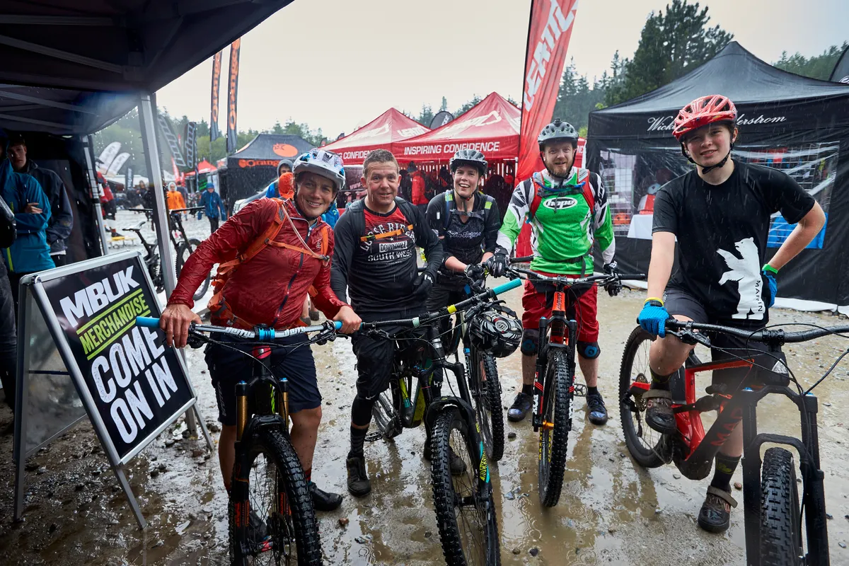 Wet and muddy riders in the pits at Fort William World Cup