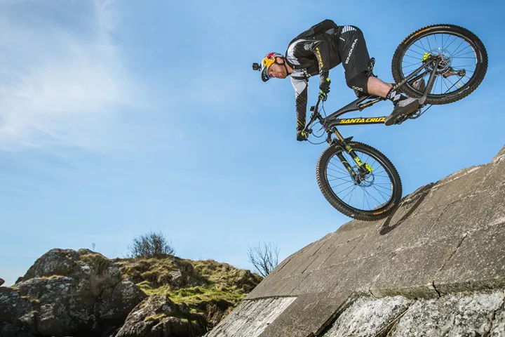 danny macaskill riding on front wheel down steep slope