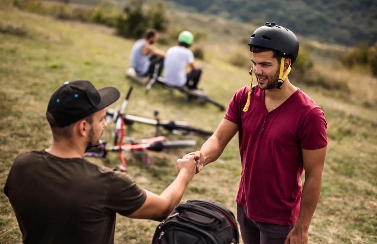 two mountain bikers doing a fist bump
