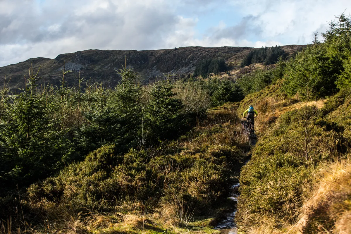 Alex Evans rides the Dolen Machno trail at Penmachno across the moor on a Wrecking Crew feature