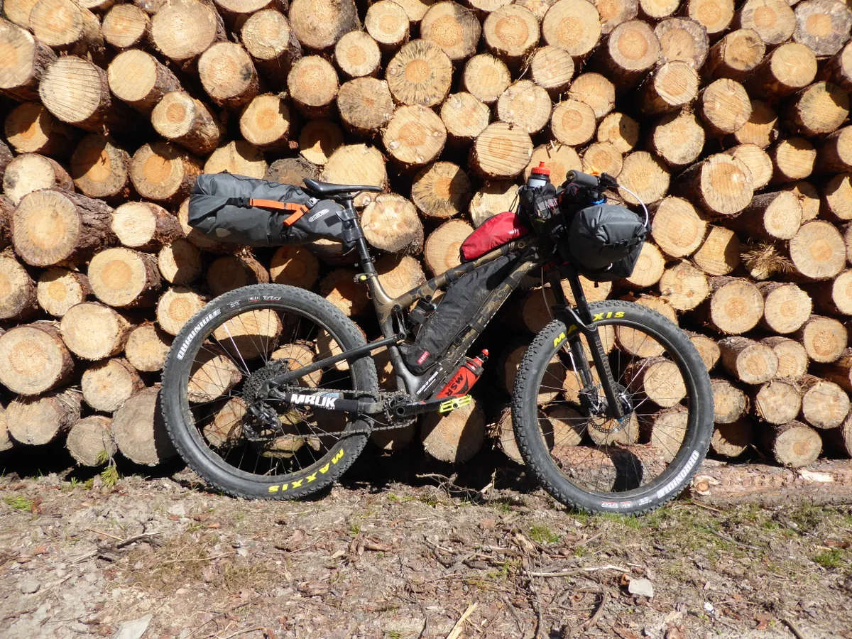 Loads fo travel kit strapped to bike packers bike