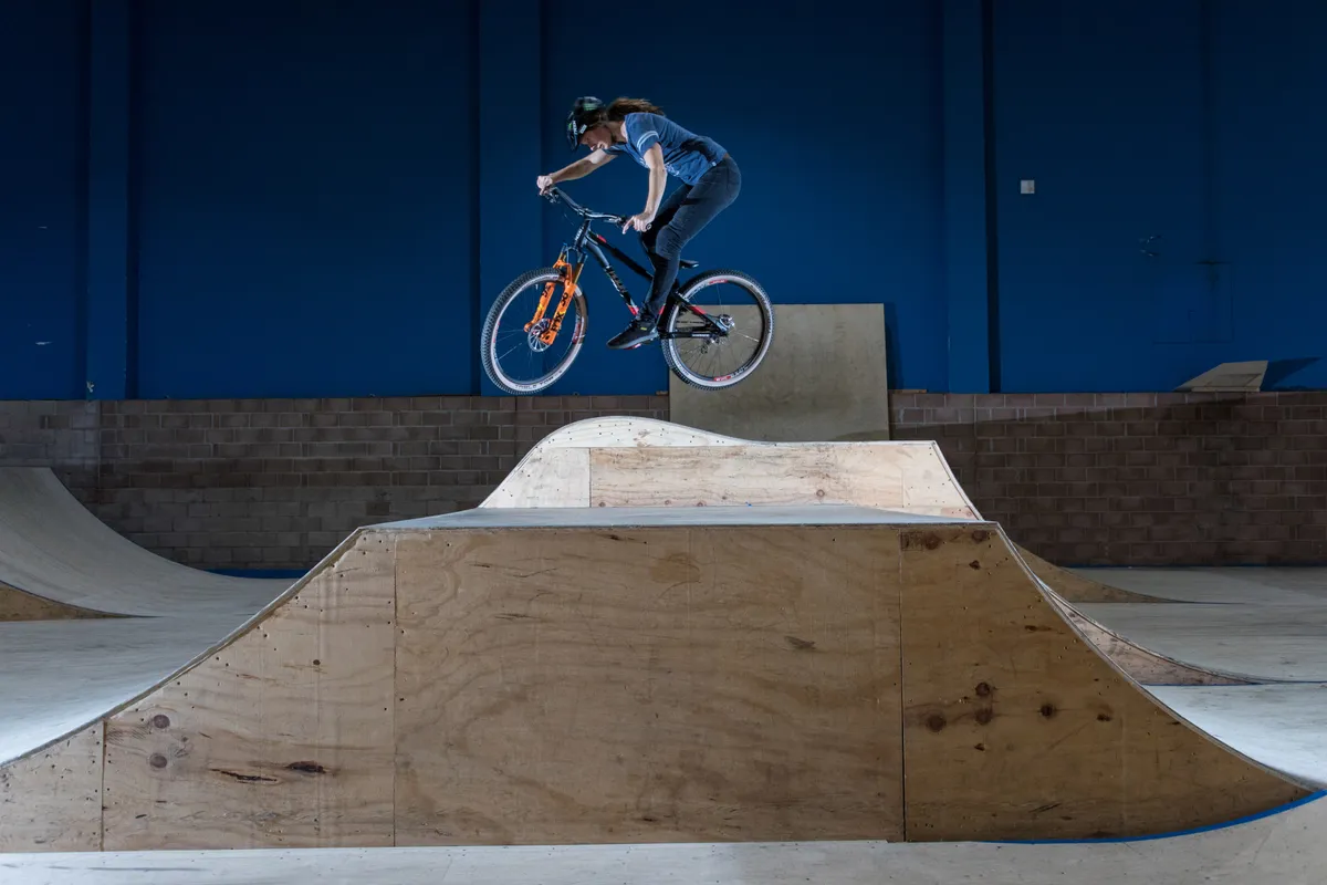Manon Carpenter jumps a ramp in Rampworld skatepark in Cardiff