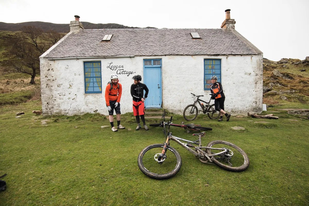 Riders chill out by and abandoned cottage on the Isle of Arran