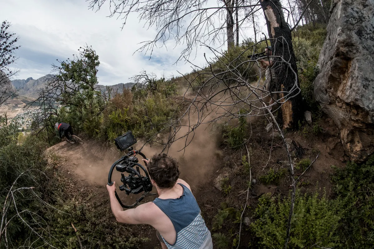 Filmer Robbie Meade using a steady cam rig to track the World Cup pace action. Photo: Duncan Philpott