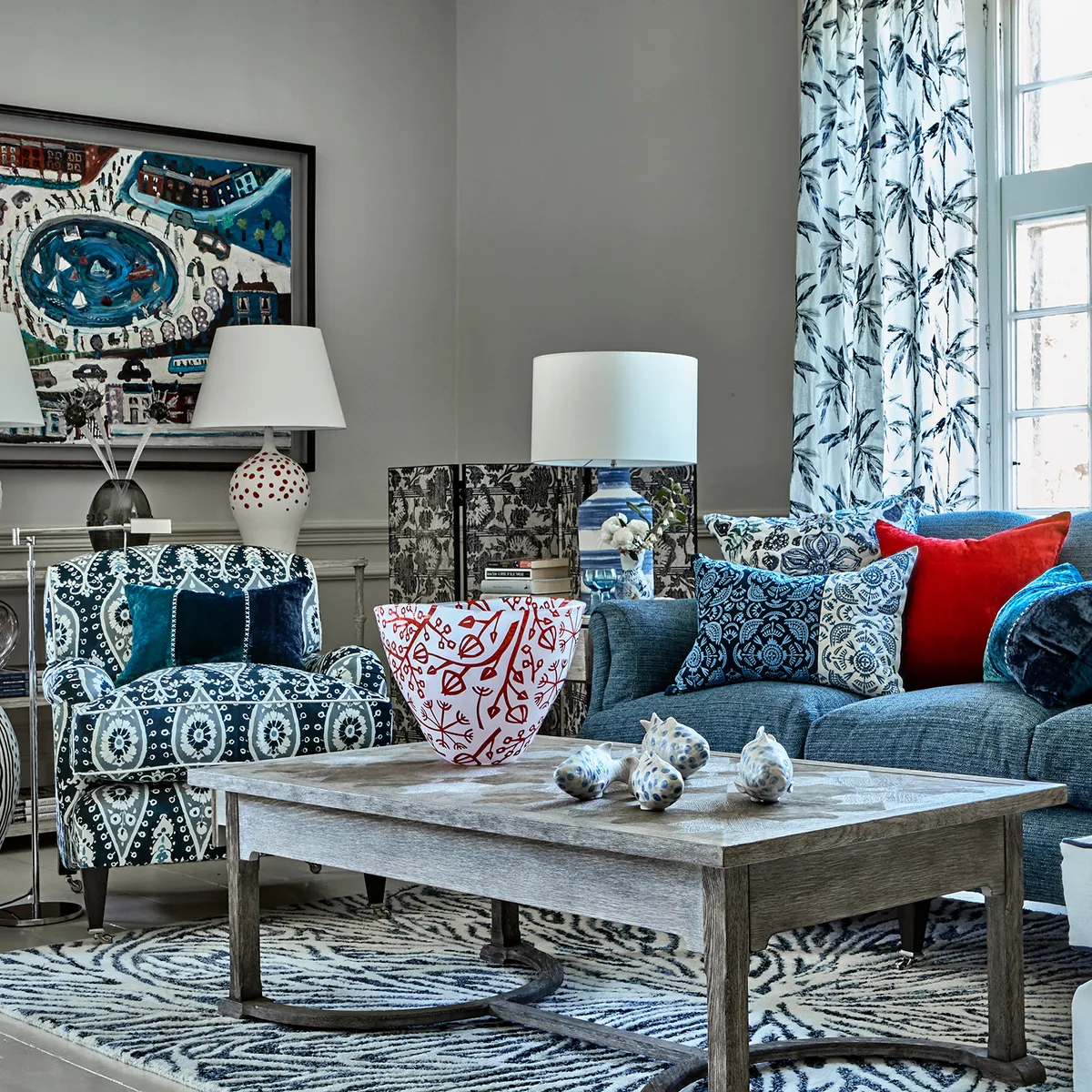 To give nautical blues a comfy cottage twist, clash blue patterned fabrics and add splashes of red. Image by Amara