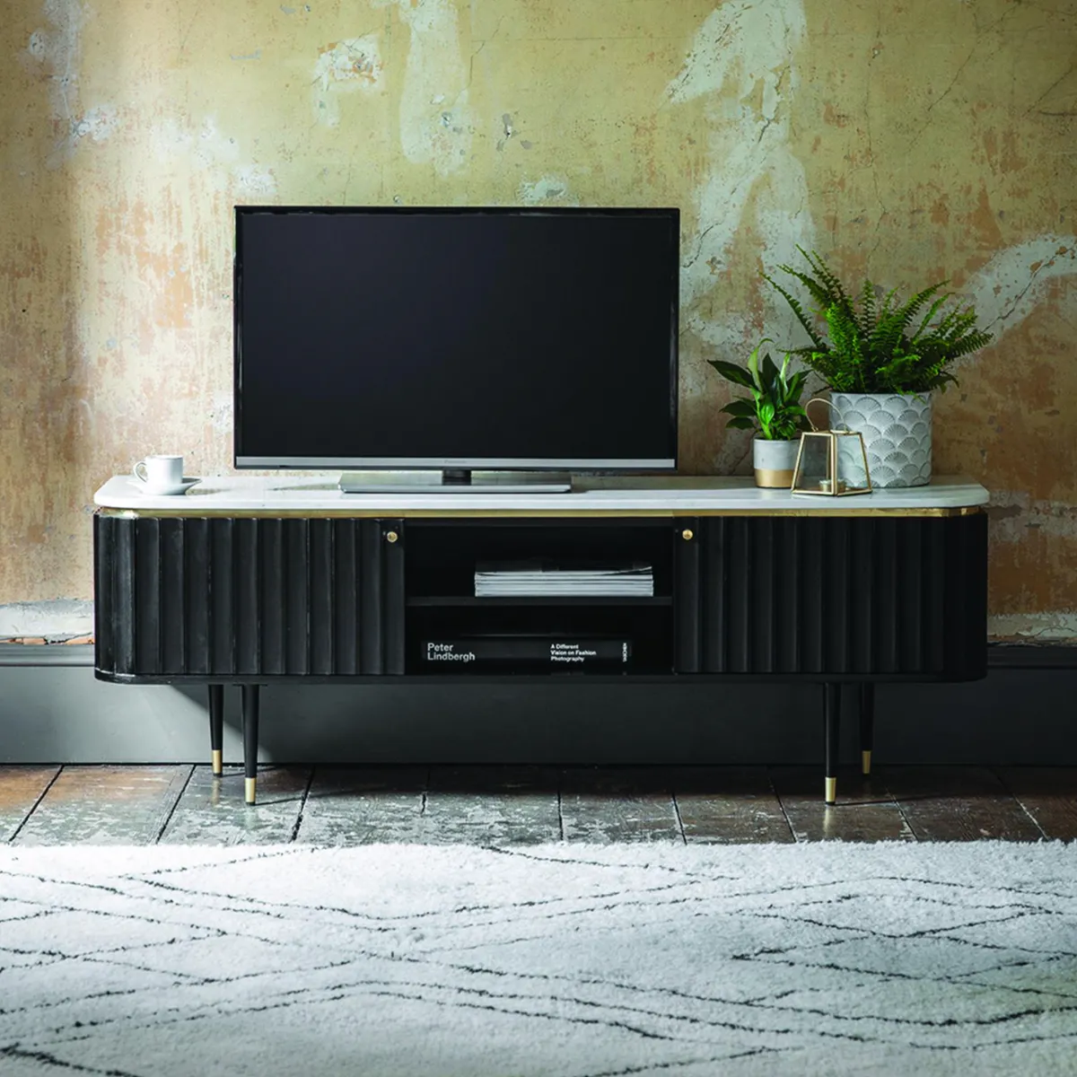Fluted finishes add texture and depth to a space. Pair with luxurious materials such as brass and marble for a luxury look Black Flute marble media unit, £549, Atkin & Thyme