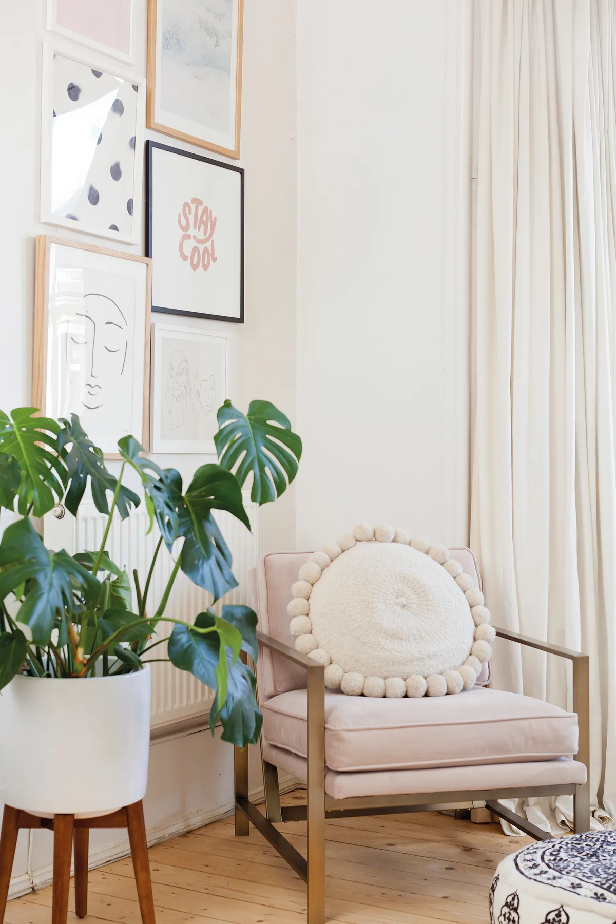 Kate has broken up the white walls with a gallery display of prints from Oliver Bonas, Etsy and Society6. The corner is also a reading nook with a metal frame chair from West Elm