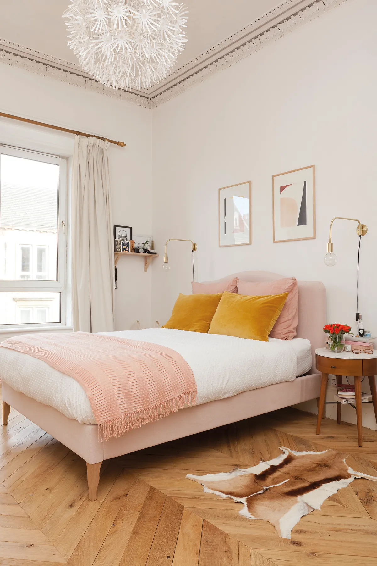 Kate wanted a mix of styles in her bedroom, which continues the muted colour scheme of her flat. The blush pink bed is from Made.com and the mid-century bedside tables are from West Elm