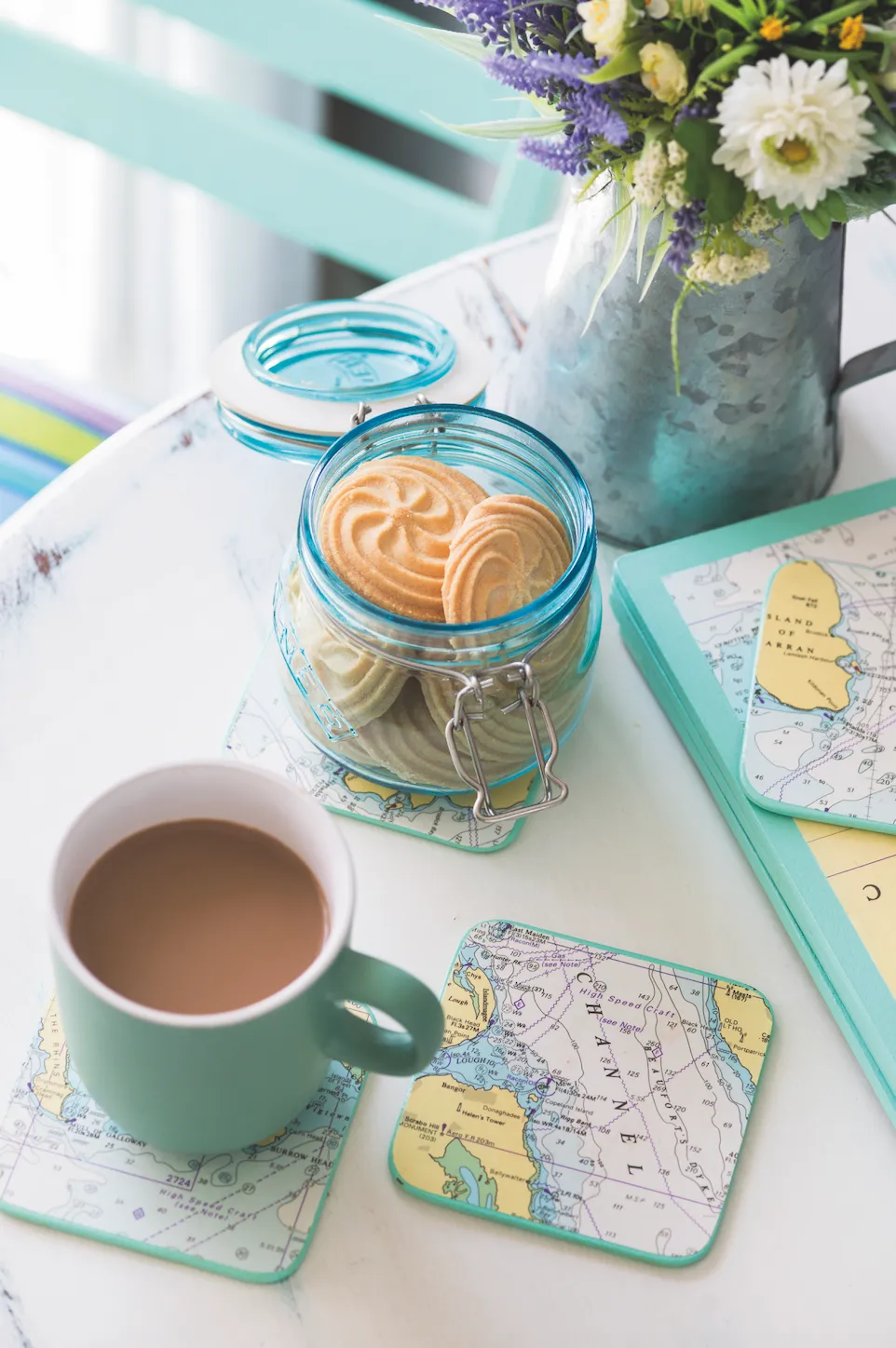 Real home - map motif coasters on a white coffee table