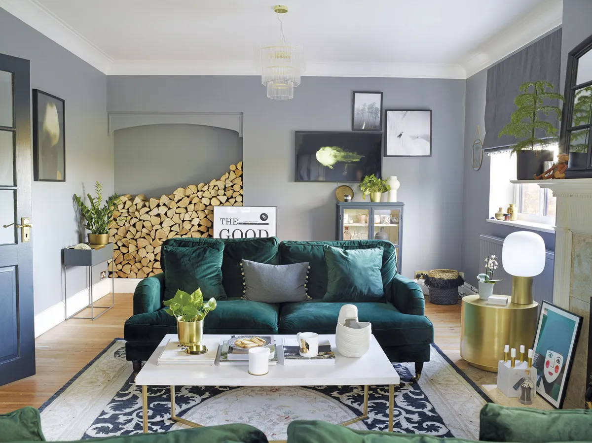 A pair of Rupert three-seater sofas from Dunelm adds a sumptuous feel to the living room, with plenty of space for guests to sit. A Gooch rug and marble coffee table adds to the decadent feel, with walls painted in Double Empire Grey by Zoffany providing a glamorous backdrop for the cocktail hour vibe