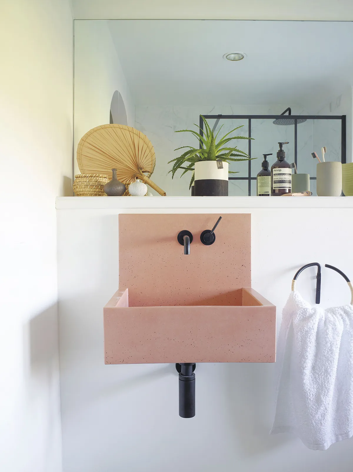 The design of Hayley’s en suite centres on her pink Kast basin, with its clean lines and Scandi-inspired design