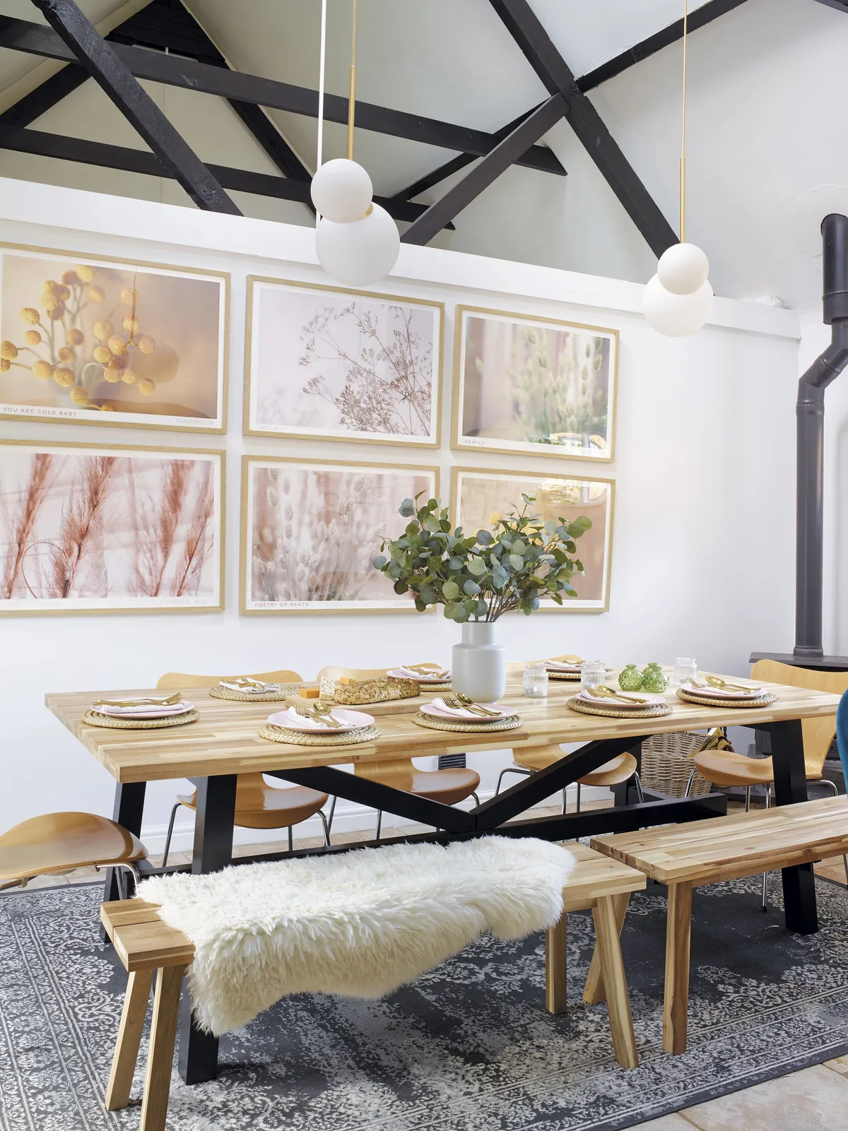 Overhead lighting from House Doctor at Amara provides a touch of glam at mealtimes, while the Viscose blue rug from Benuta and Shaneen Rosewarne Cox wall art adds a homely touch