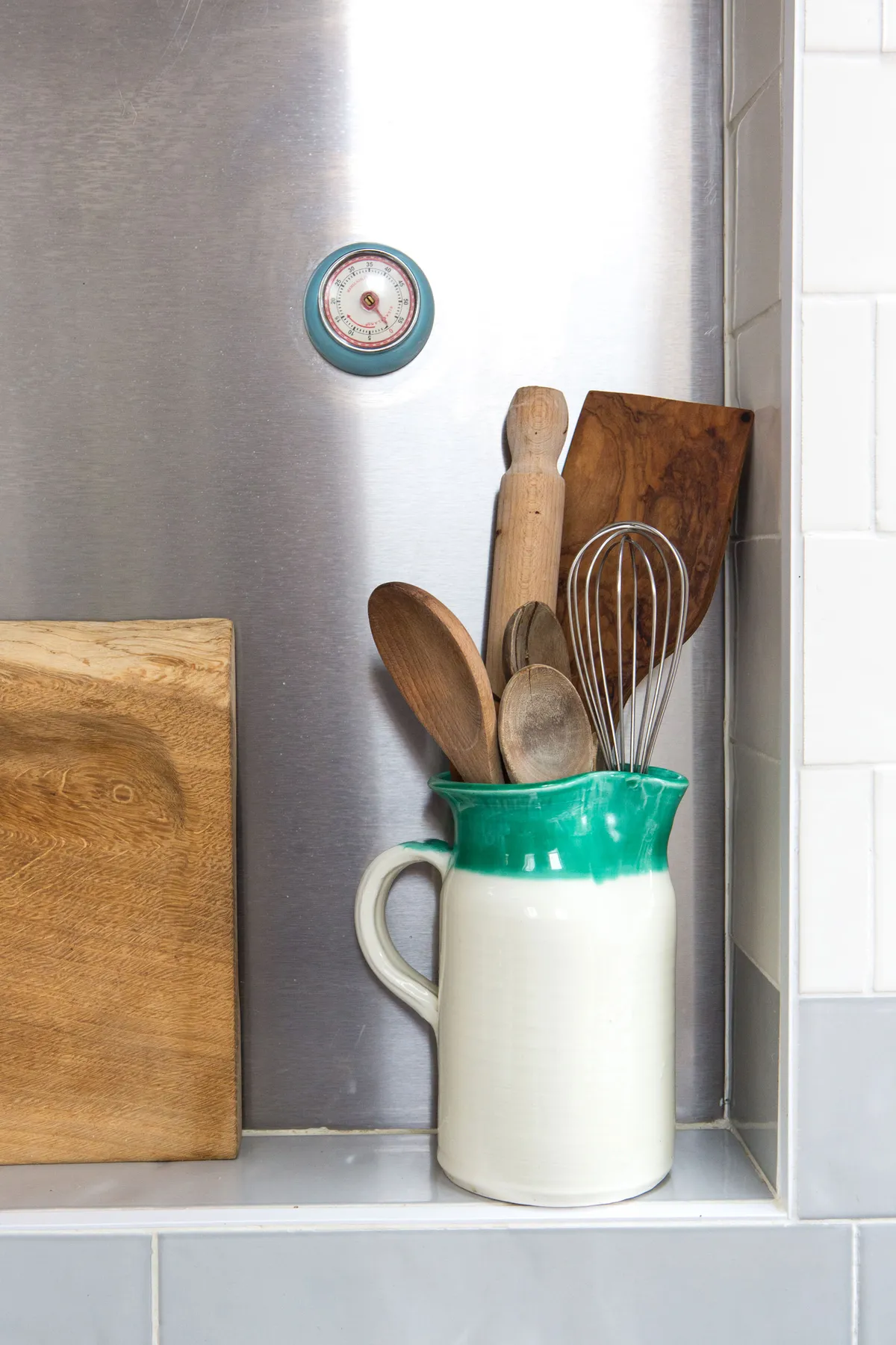 Kitchen makeover - wooden utensils in a bright ceramic jug