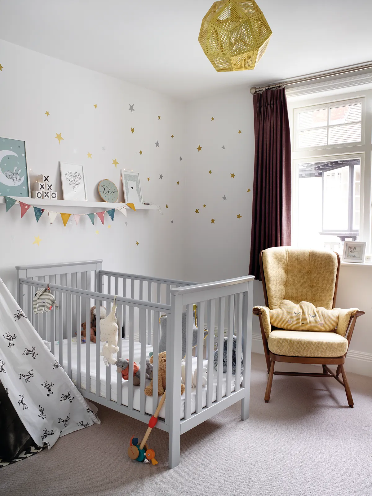 ‘I didn’t want to spend a lot on Theo’s room as he’ll grow out of it. I used decals on a neutral wall and added prints, bunting and fairy lights for texture and interest’ says Sarah