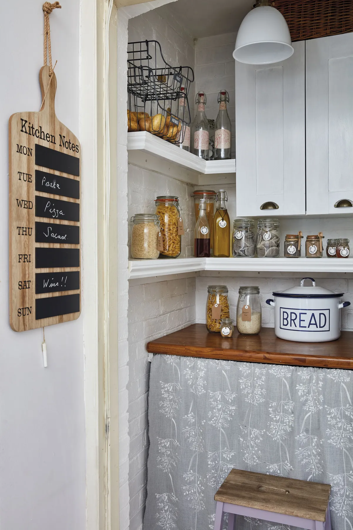 The little pantry provides much-needed storage space in the kitchen. ‘It used to have everything just thrown in there, until we put in the little cupboards, re-did the shelving and changed the light fitting,’ Sharon says. ‘The wooden worktop was covered by ugly vinyl plastic, which we peeled off.’ The little curtain hides the washing machine