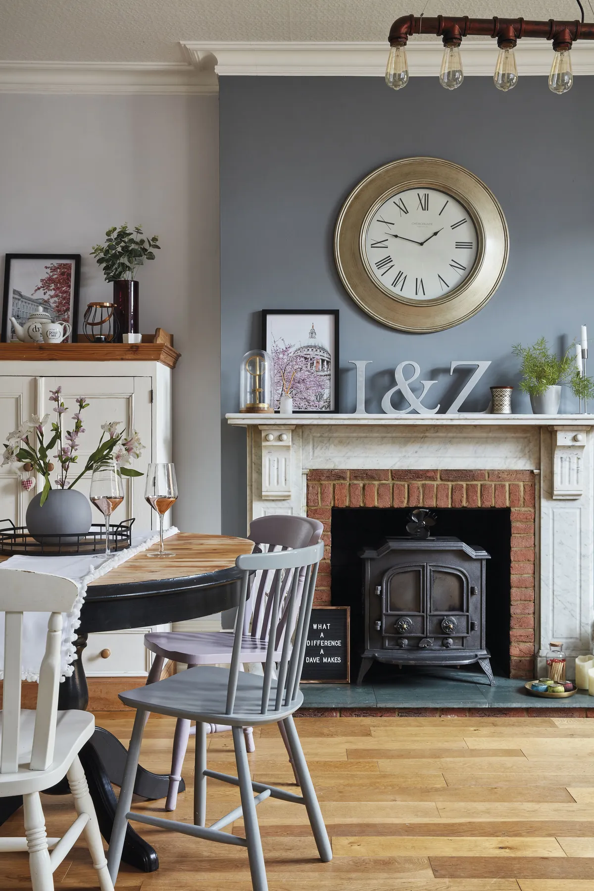 The dining table is one of Sharon’s many upcycling projects, which she painted in black Rust-Oleum paint. She then turned her attention to the chairs. ‘I used leftover paint from my front door for some of the dining chairs because I wanted to bring more of the lilac colour into my home.’ Above the fireplace hangs an oversized clock from Dunelm
