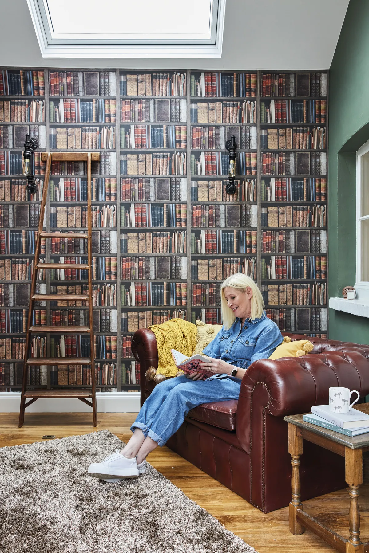 Good idea! Fake a home library with book wallpaper. You could even prop up a ladder to complete the look!