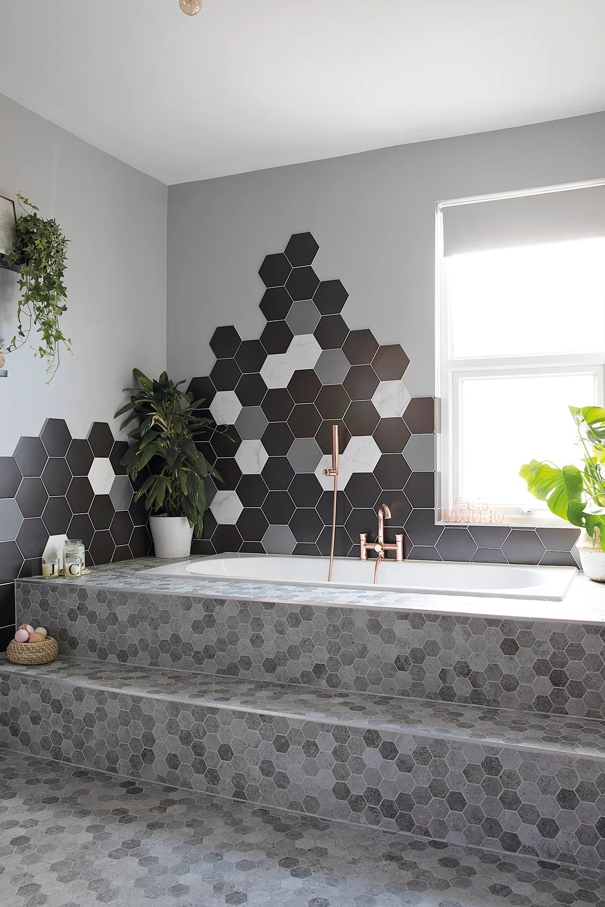 A boutique style bathroom with hexagon wall tiles