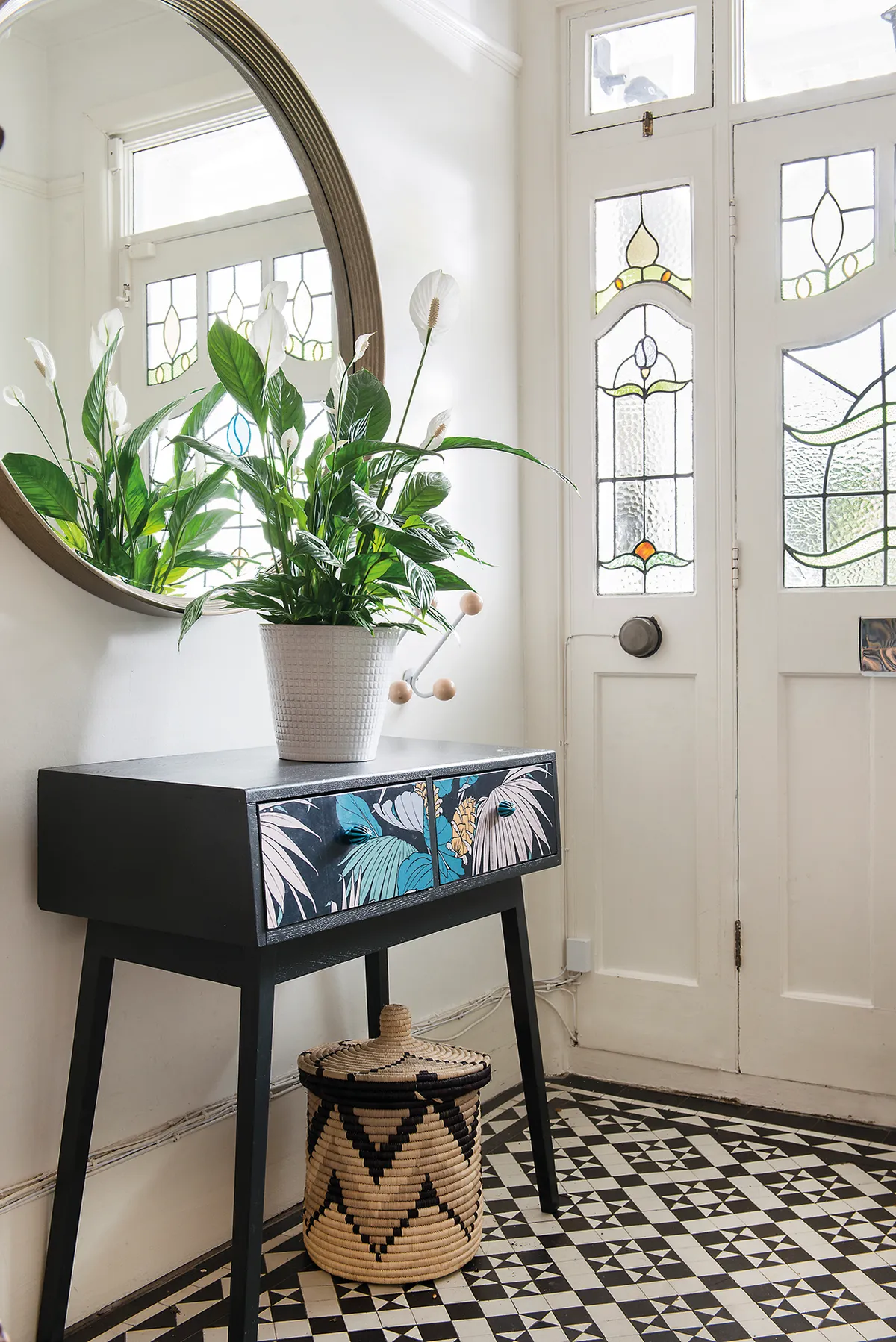 Original features, such as the hall’s practical, tiled floor and pretty stained glass windows were a big draw for Sophie and Rich. The console table, which Sophie picked up on eBay, has been transformed with paint, découpage and new handles