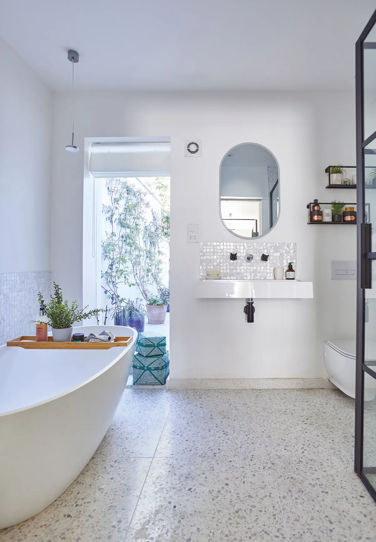 In the window of the en suite, Shrez has added Balinese storage baskets from La Redoute to add a pop of colour. The industrial-style taps are from Meir Black