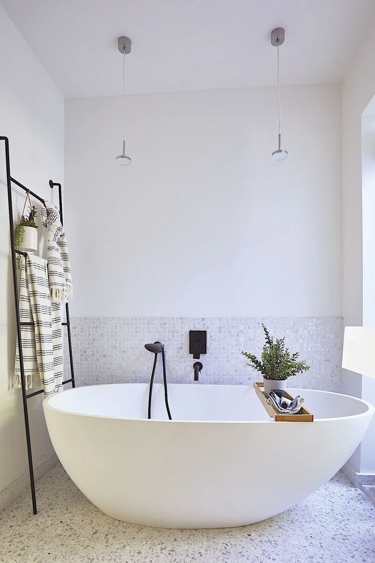 For a clean, modern look Shrez went for an all-white scheme with elements of matt black, tying features such as the black mixer taps over the free-standing bath with the ladder towel rail