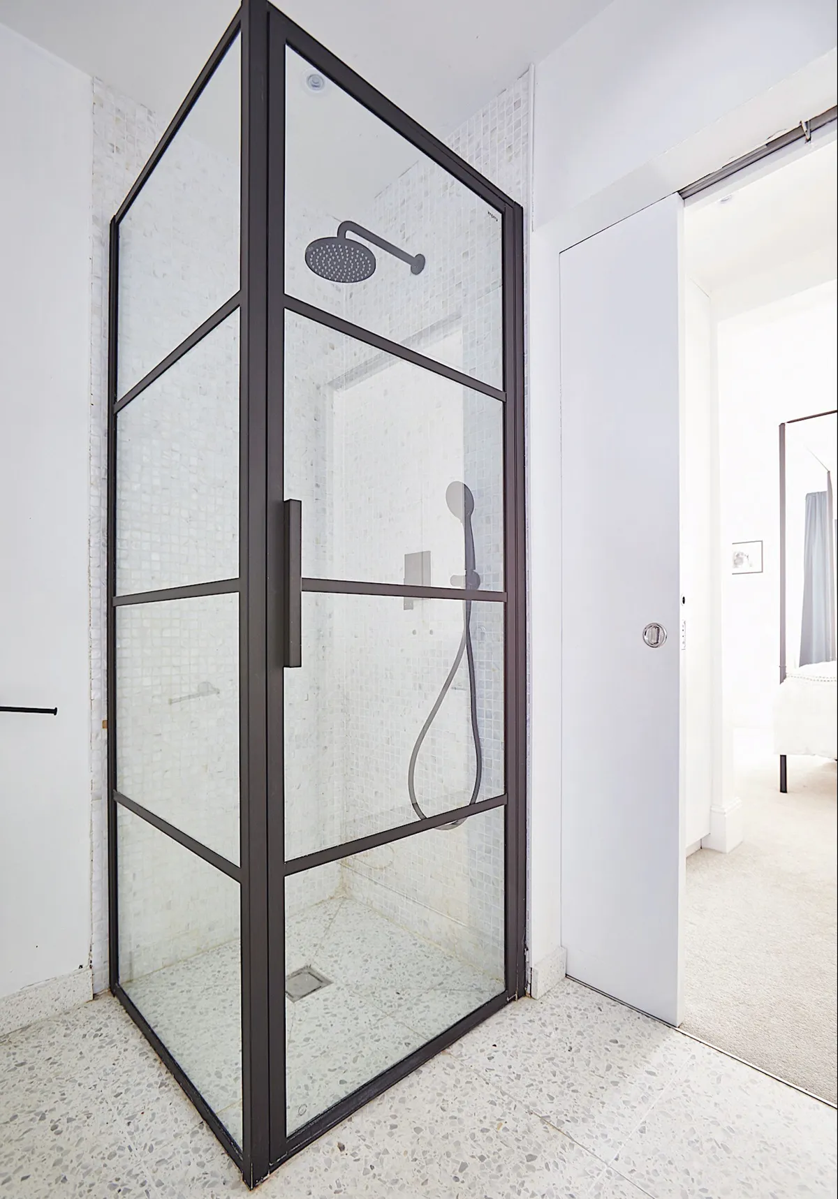 The black-framed shower screen, from Impey Showers, gives this bathroom a polished look