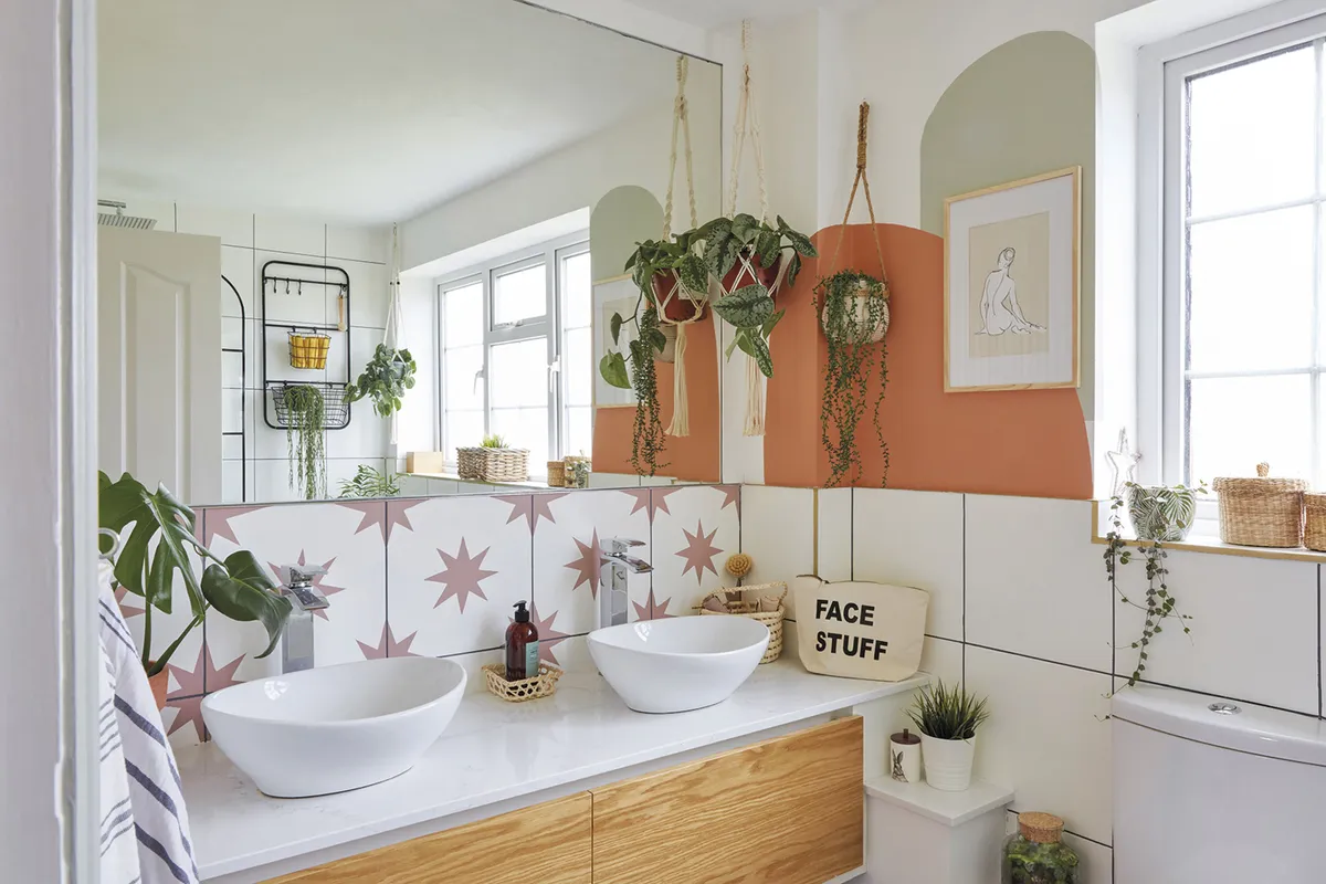‘The bathroom is a good size, but I wanted to make it feel more spacious, so I added the mirror and orange paint to add interest. The units were already there, and I painted the tiles. I’m really happy with them – they look like the real thing!’