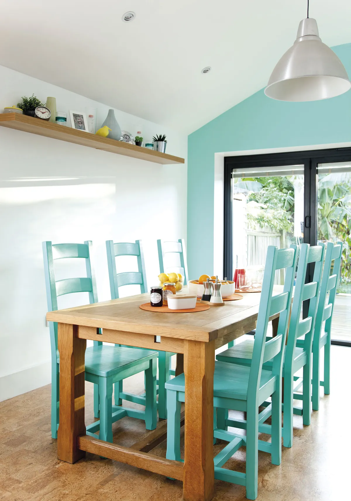 Bev’s chairs were looking tired so she painted them a fresh blue-green, which, when teamed with orange, gives the room a summery, tropical feel