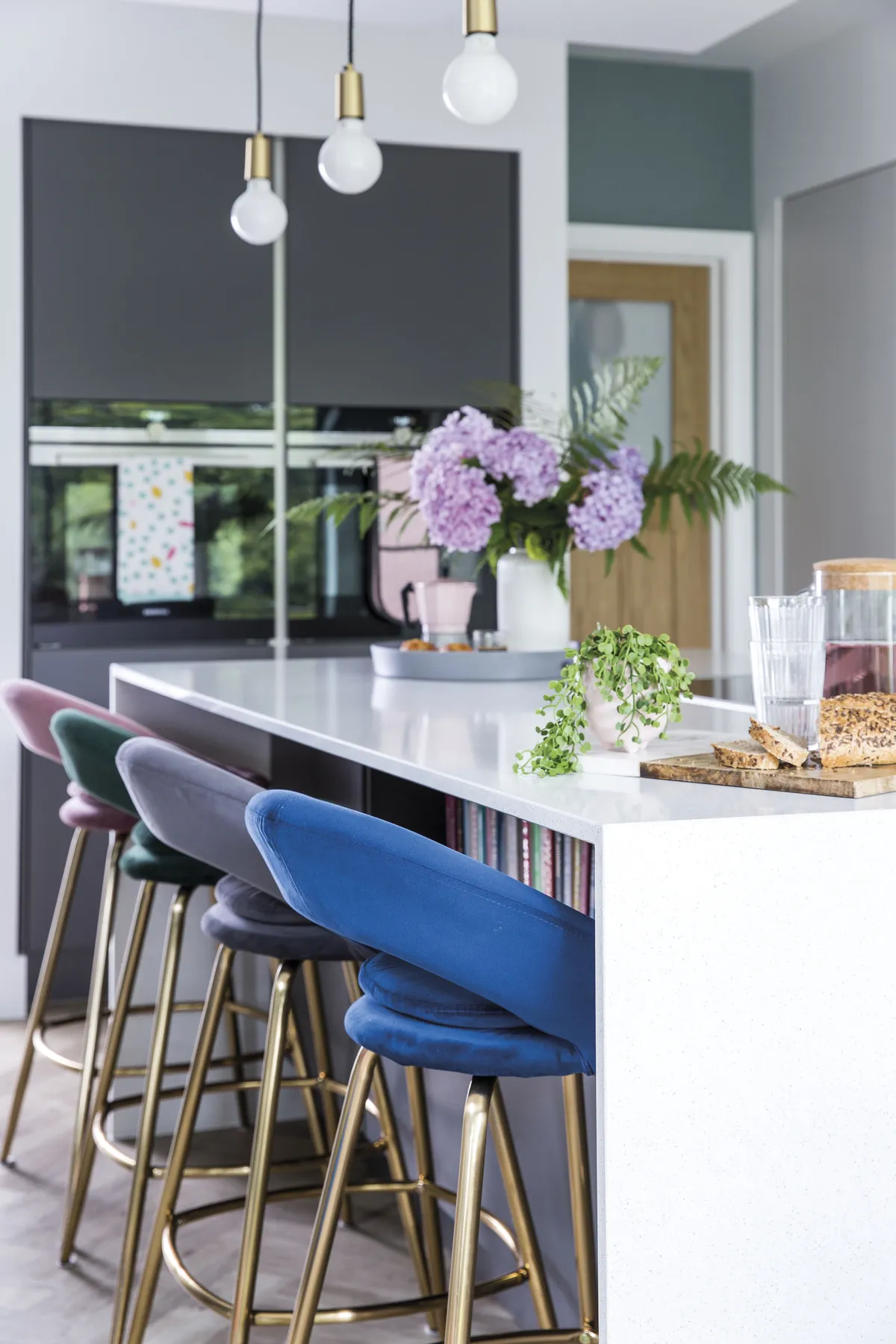 The breakfast bar area is a much-used part of the kitchen now and the kids love the velvet stools that Rebecca bought in different pastel shades