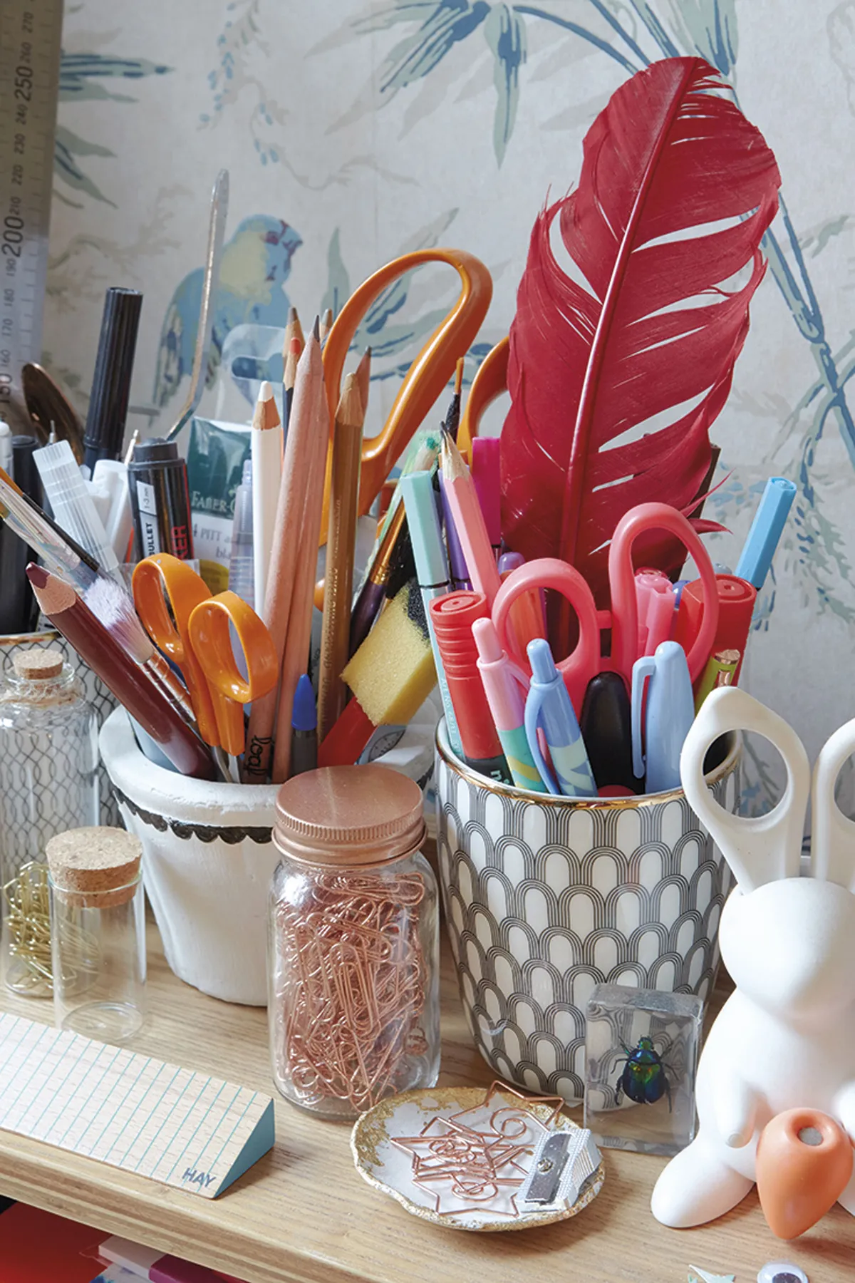 Emily’s desk holds an assorted mix of craft equipment. ‘I teach calligraphy and brush lettering, so I have a lot of quills, ink and pens,’ says Emily