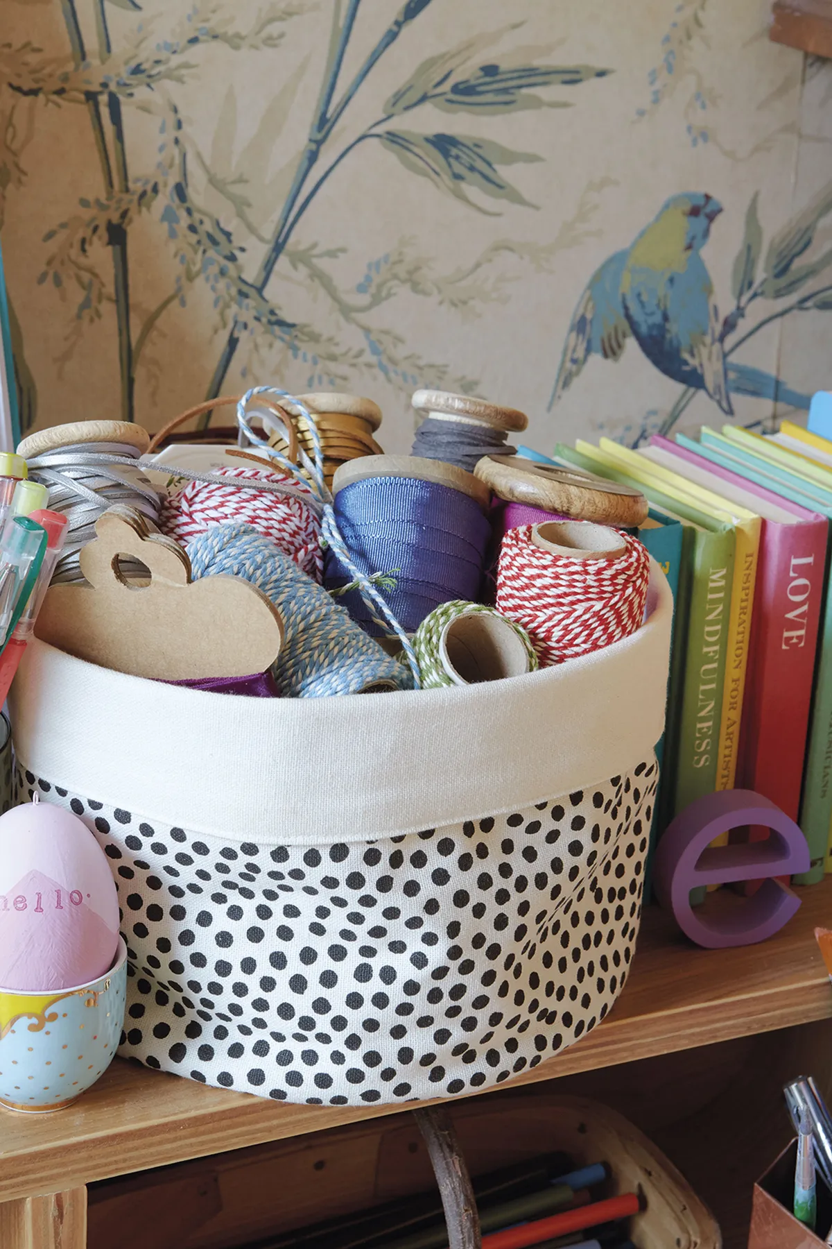Storage is a top priority in Emily’s craft room. ‘I don’t want to hide everything away in boxes, so things like ribbons and twine need to be seen. Displaying them in this fabric basket from H&M Home is ideal – pretty and practical’