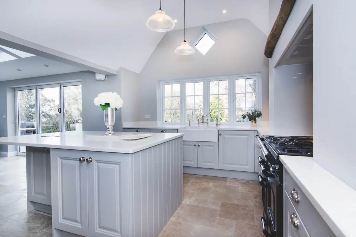 The Pale Grey finish of this traditional Shaker Gainsborough cabinetry from Mereway’s Town & Country collection helps distribute light throughout this kitchen extension, and enhance the sense of openness. Kitchen prices start from £14,000