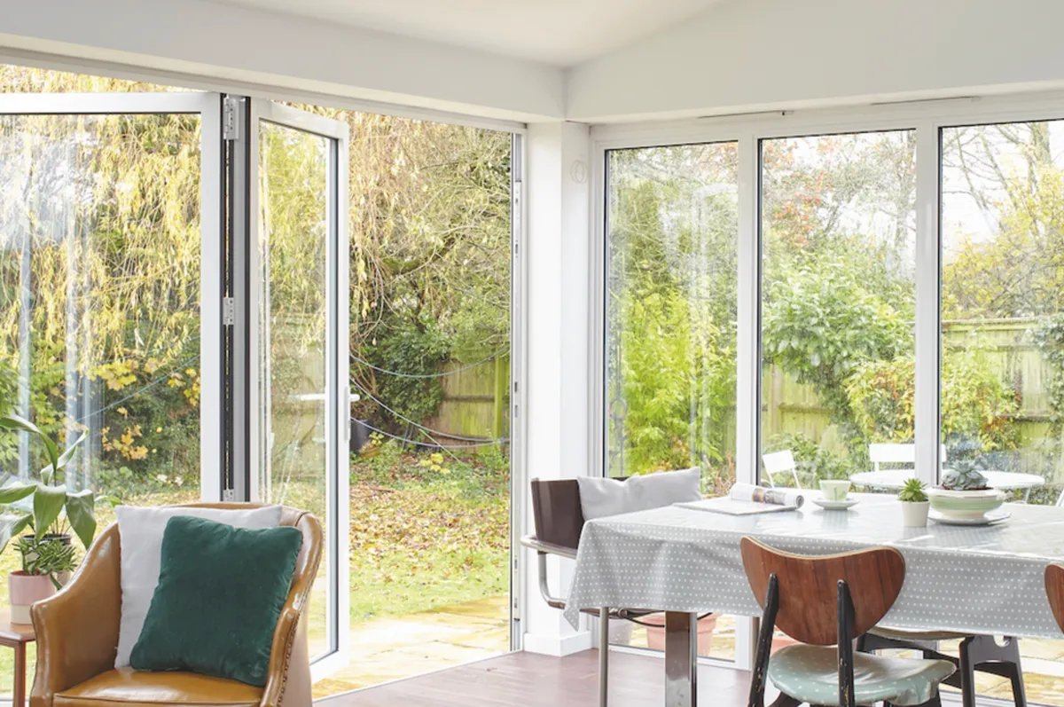 Keen to encourage plenty of calming natural light and create a connection with the pretty garden, the full-height windows were extended around the corner for a striking effect
