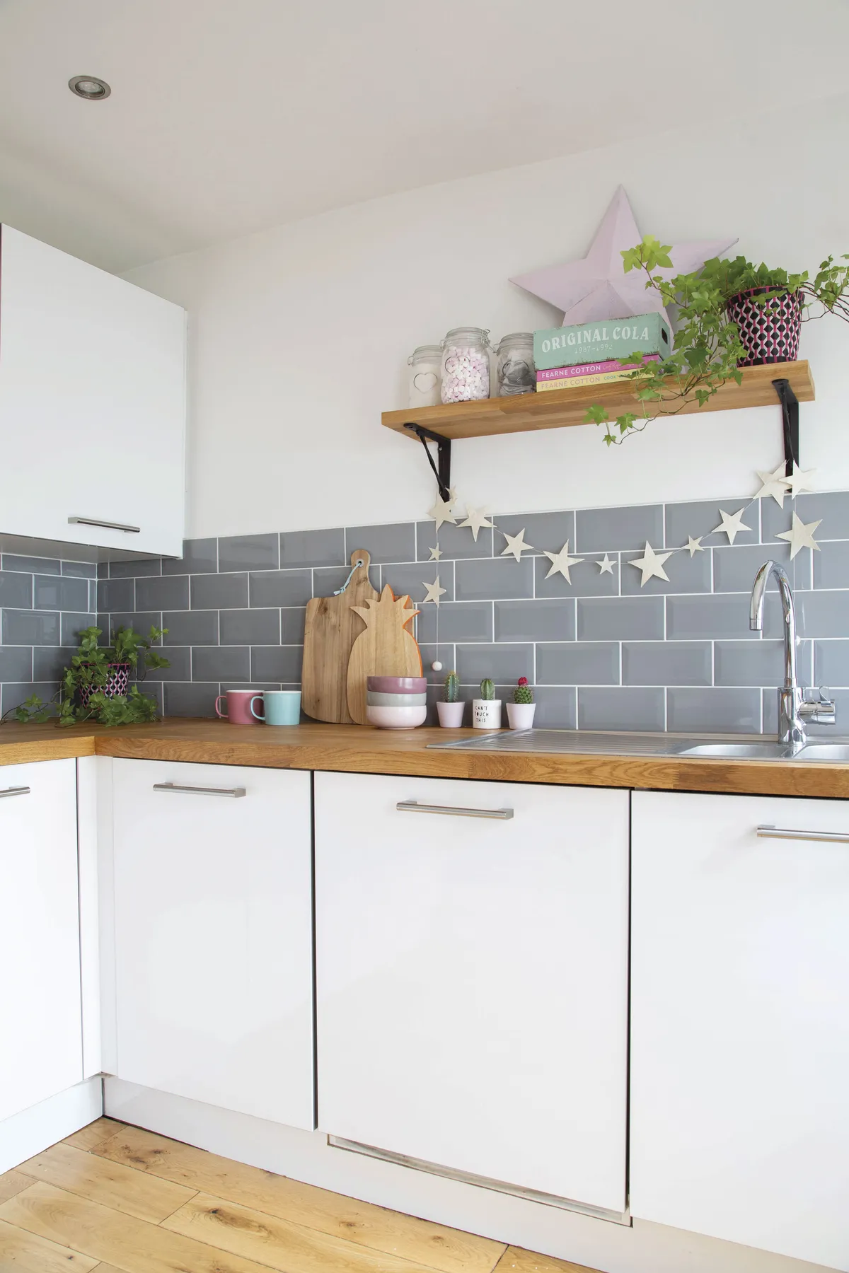 The original, behind-the-times kitchen was hastily removed the day the couple moved in to allow room for their appliances. In its place, they fitted simple, unfussy units and low-cost tiles to, once again, allow artwork to take centre stage