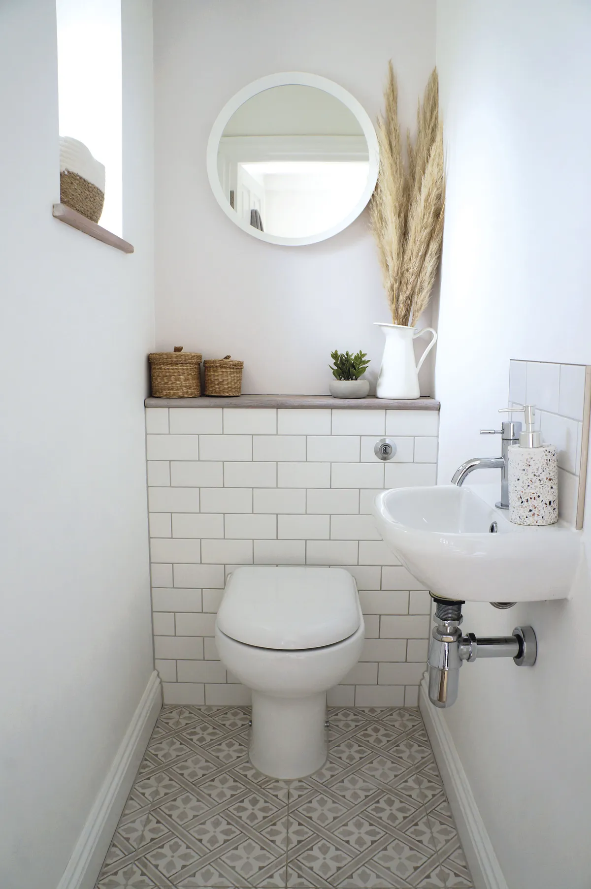 ‘This part of the house was originally a cold and damp outhouse,’ Jade says. ‘We chose a hidden cistern so I could display items on the shelf and added a wall-hung sink. The patterned floor tiles are part of the Mr Jones range from Laura Ashley.’