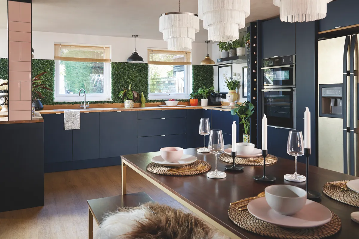 The couple complemented the dark navy-blue units with natural oak worktops and flooring